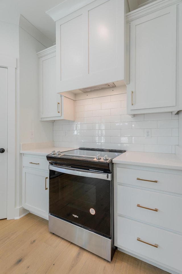 9532 N Valley Trl, Ooltewah, TN 37363 - kitchen featuring electric range, decorative backsplash, light countertops, light wood-style flooring, and white cabinetry