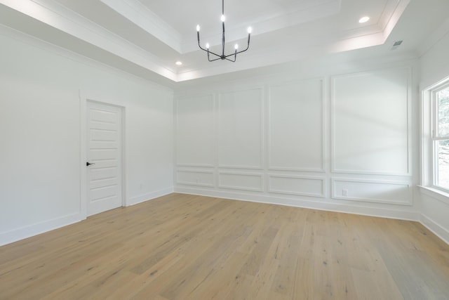 9532 N Valley Trl, Ooltewah, TN 37363 - unfurnished dining area with a decorative wall, a tray ceiling, ornamental molding, a chandelier, and light wood-type flooring