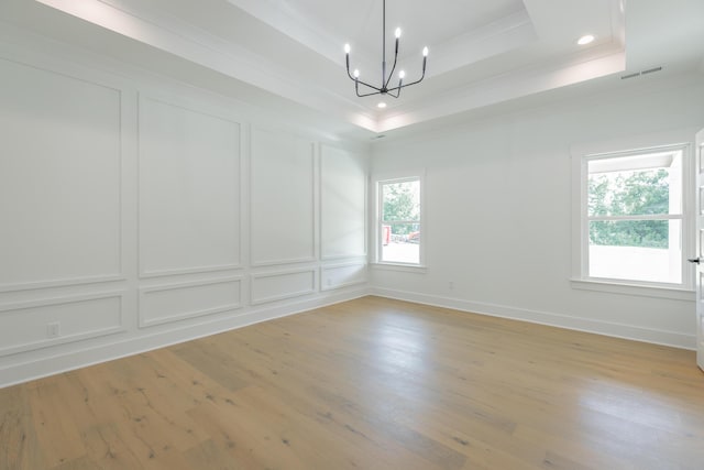 9532 N Valley Trl, Ooltewah, TN 37363 - unfurnished room with crown molding, a tray ceiling, a chandelier, a decorative wall, and light wood finished floors