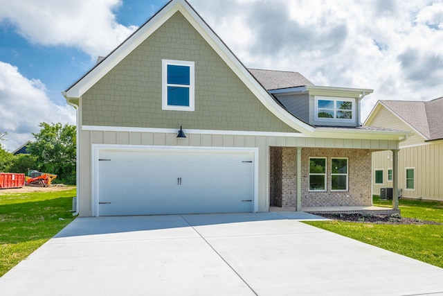 9532 N Valley Trl, Ooltewah, TN 37363 - view of front of home with a garage, a front yard, a porch, and concrete driveway