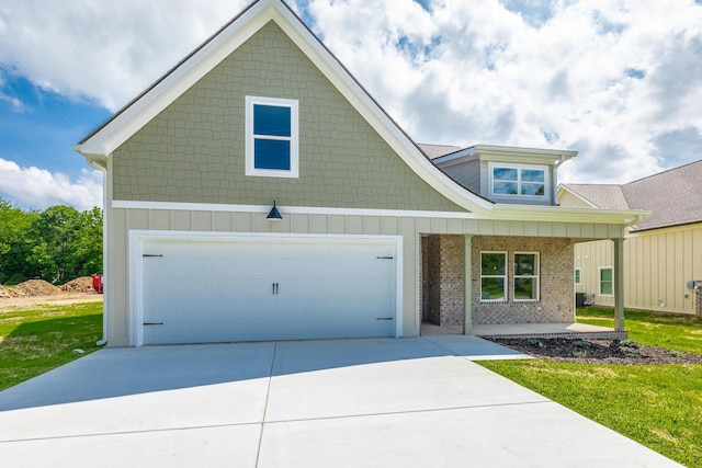 9532 N Valley Trl, Ooltewah, TN 37363 - view of front facade featuring covered porch, driveway, a front lawn, and brick siding
