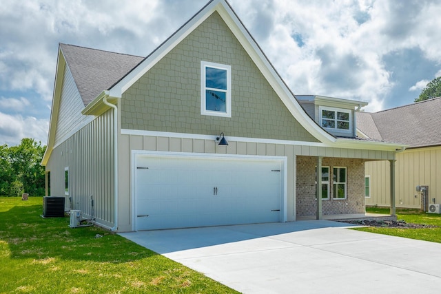 9532 N Valley Trl, Ooltewah, TN 37363 - view of front of home with central air condition unit, a front yard, concrete driveway, and a shingled roof