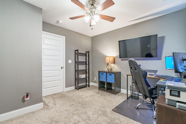home office featuring carpet flooring, a ceiling fan, and baseboards