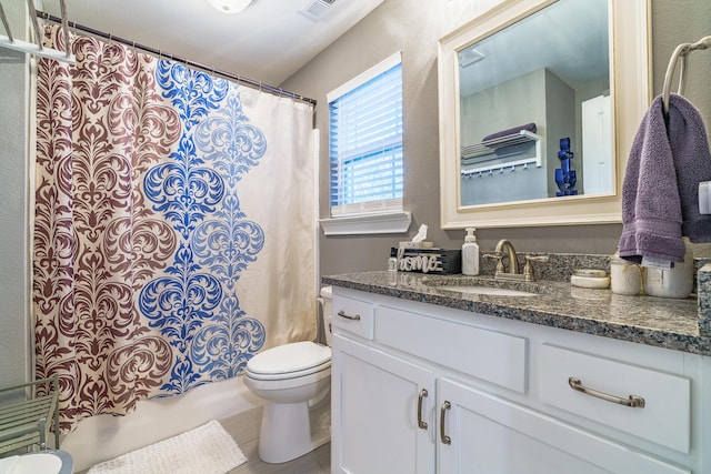 bathroom featuring toilet, vanity, and shower / bath combo