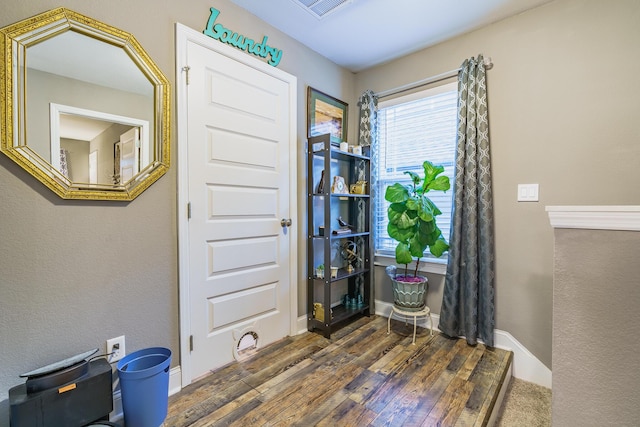miscellaneous room featuring hardwood / wood-style floors and baseboards