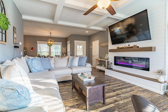 living area featuring a glass covered fireplace, coffered ceiling, dark wood-type flooring, ceiling fan, and beam ceiling