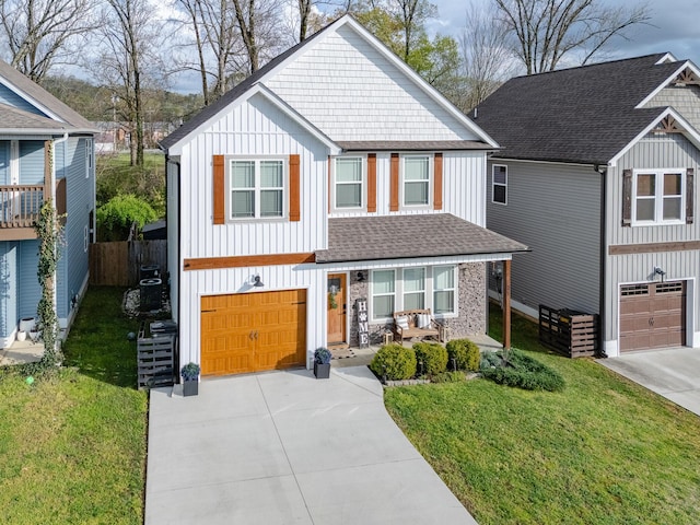 view of front facade with driveway, board and batten siding, an attached garage, and a shingled roof