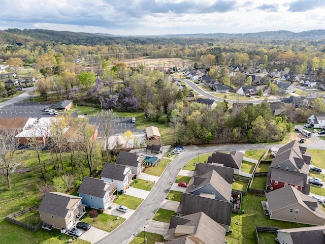 aerial view of property's location with nearby suburban area and a forest
