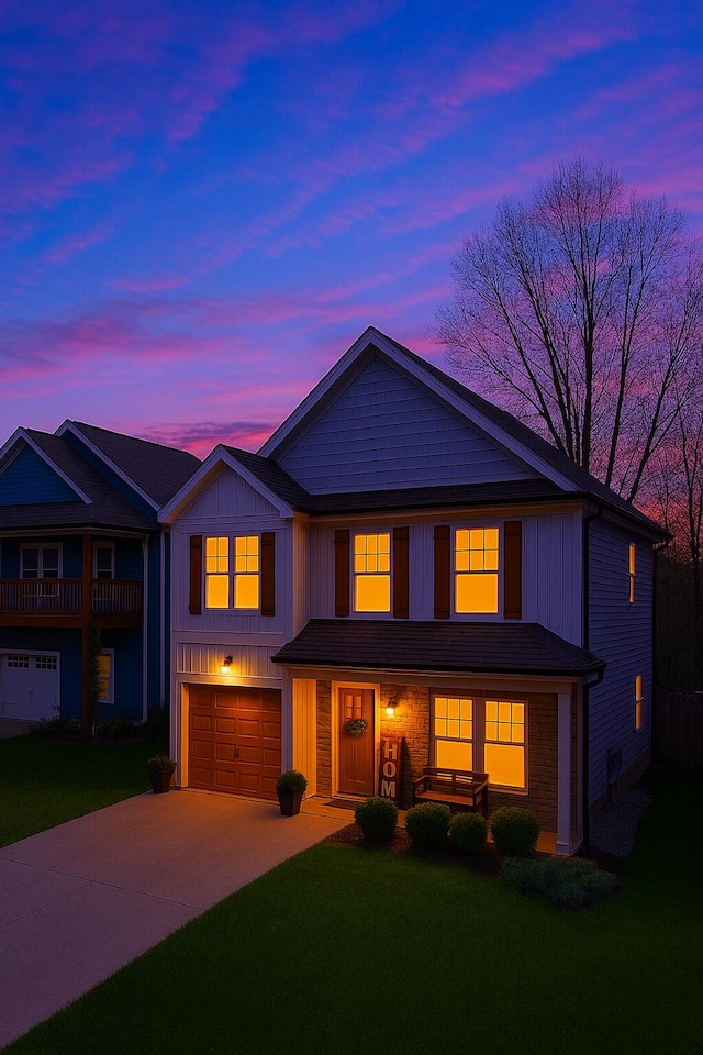 view of front of home with a garage, driveway, a front lawn, and board and batten siding