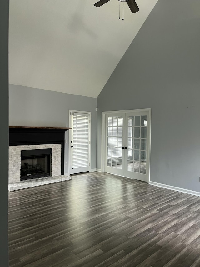 unfurnished living room featuring dark wood-style flooring, high vaulted ceiling, french doors, a ceiling fan, and baseboards