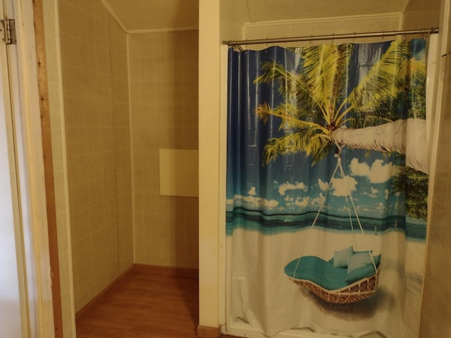 bathroom with crown molding and wood finished floors