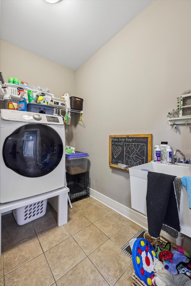 laundry area with baseboards, washer / clothes dryer, laundry area, and tile patterned floors