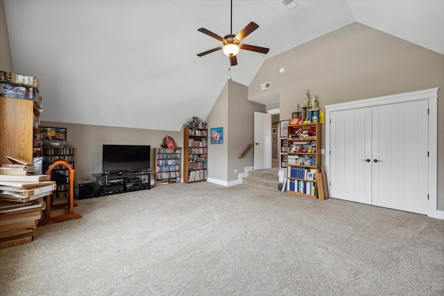carpeted living area featuring baseboards, lofted ceiling, visible vents, and ceiling fan