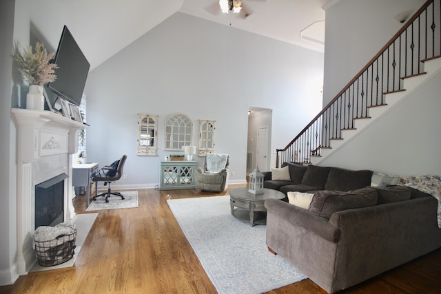 5553 Jonquil Ln, Ooltewah, TN 37363 - living area with high vaulted ceiling, stairway, wood finished floors, a ceiling fan, and baseboards
