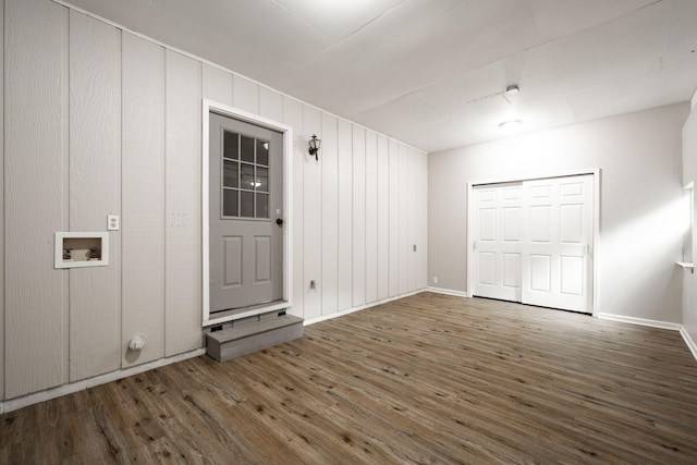 interior space featuring baseboards and wood finished floors
