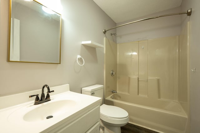 full bathroom featuring shower / washtub combination, toilet, vanity, and a textured ceiling