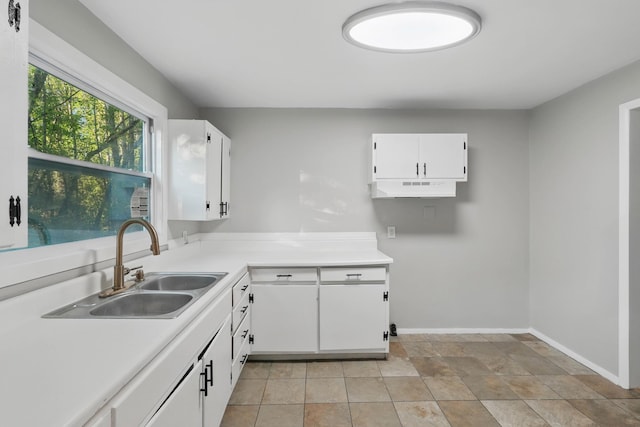 5503 Oleary St, Chattanooga, TN 37410 - kitchen featuring light countertops, a sink, white cabinetry, and baseboards