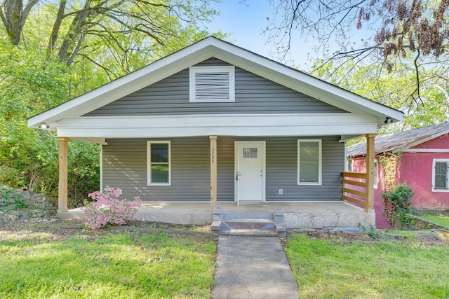 bungalow-style home featuring a porch and a front lawn