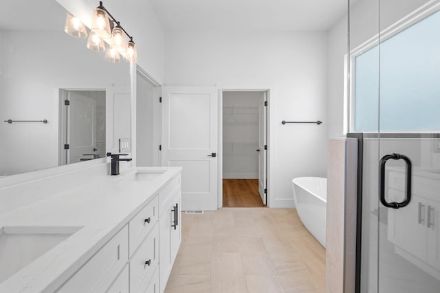 3354 Hawks Creek Dr, Apison, TN 37302 - bathroom with double vanity, a freestanding tub, a spacious closet, and a stall shower