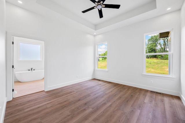 3354 Hawks Creek Dr, Apison, TN 37302 - empty room with wood finished floors, ceiling fan, a tray ceiling, and recessed lighting