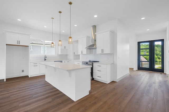 3354 Hawks Creek Dr, Apison, TN 37302 - kitchen with stainless steel stove, wall chimney range hood, dark wood-type flooring, healthy amount of natural light, and recessed lighting