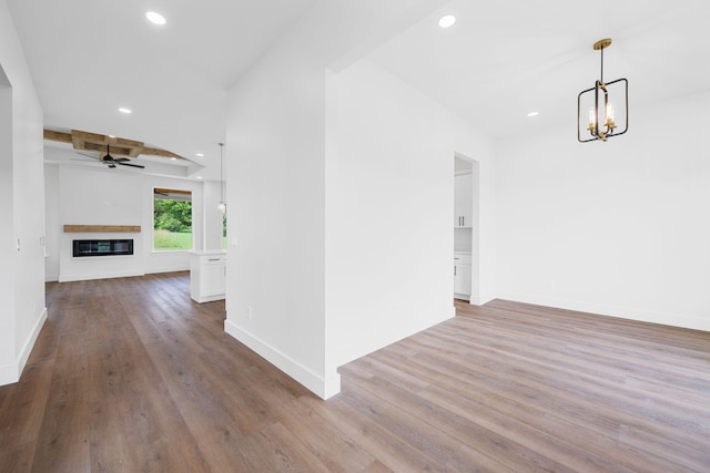 3354 Hawks Creek Dr, Apison, TN 37302 - unfurnished living room with a ceiling fan, wood finished floors, recessed lighting, a chandelier, and a glass covered fireplace