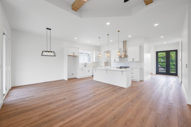 3354 Hawks Creek Dr, Apison, TN 37302 - kitchen with wall chimney range hood, plenty of natural light, light wood-style flooring, a kitchen island, and recessed lighting