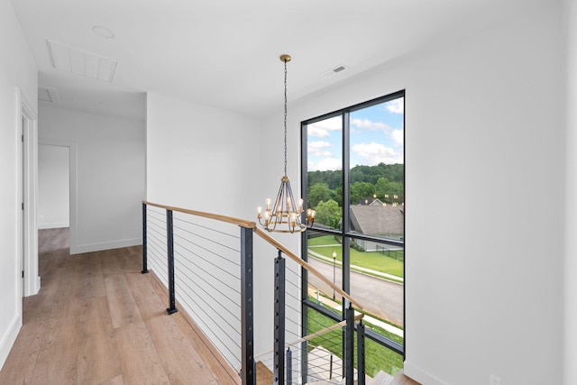 3354 Hawks Creek Dr, Apison, TN 37302 - hallway featuring a chandelier, an upstairs landing, and light wood-style floors