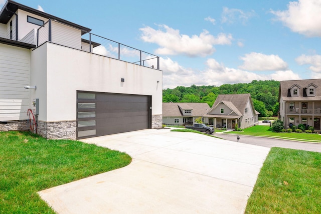 3354 Hawks Creek Dr, Apison, TN 37302 - view of front of house with a garage, driveway, a front yard, stucco siding, and stone siding