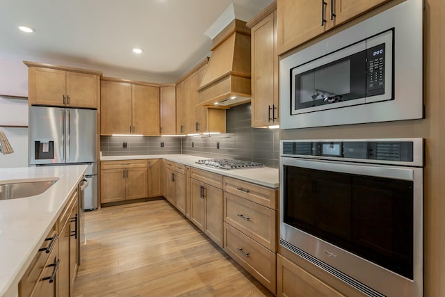 5735 Acadia Dr, Chattanooga, TN 37415 - kitchen with custom exhaust hood, a sink, light wood-type flooring, stainless steel appliances, and decorative backsplash