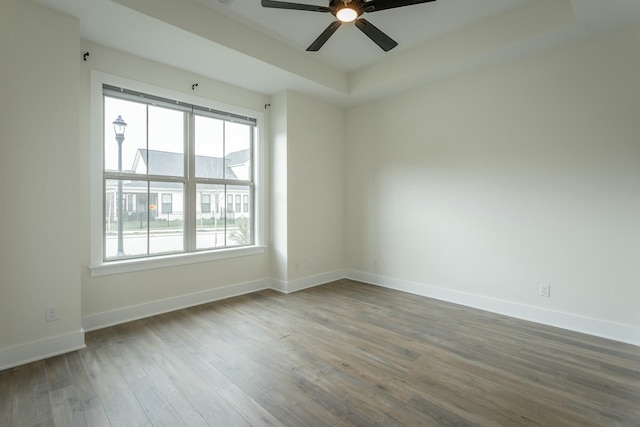 5735 Acadia Dr, Chattanooga, TN 37415 - empty room with a tray ceiling, baseboards, a ceiling fan, and wood finished floors