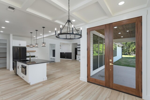 337 Hunter Trl, Trenton, GA 30752 - kitchen featuring a sink, dark countertops, a notable chandelier, light wood-style floors, and coffered ceiling