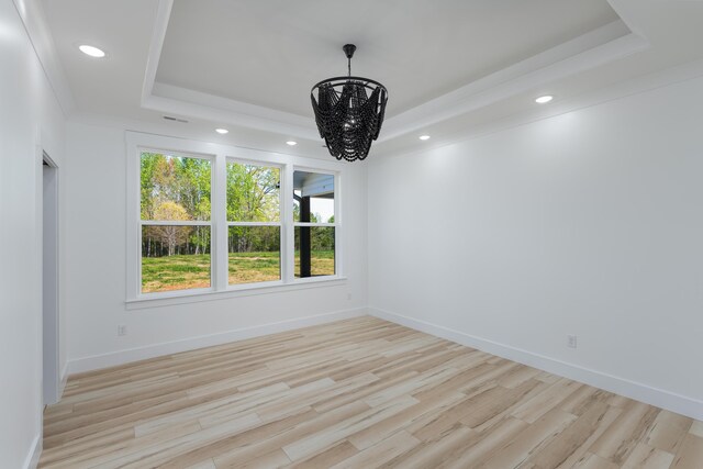 337 Hunter Trl, Trenton, GA 30752 - spare room featuring a raised ceiling, wood finished floors, baseboards, and a notable chandelier