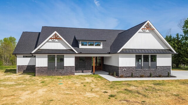337 Hunter Trl, Trenton, GA 30752 - view of front facade featuring stone siding, a standing seam roof, and a front lawn