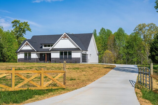 337 Hunter Trl, Trenton, GA 30752 - view of front of house featuring concrete driveway, a front lawn, stone siding, board and batten siding, and fence private yard