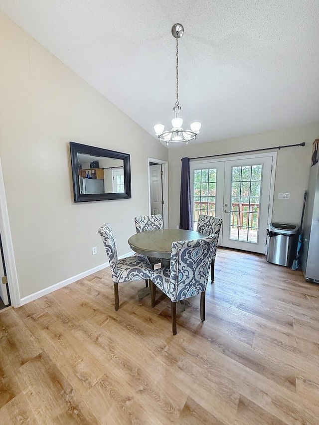 1319 Jacobs Ave, Bridgeport, AL 35740 - dining room with a textured ceiling, an inviting chandelier, french doors, light wood-style flooring, and lofted ceiling
