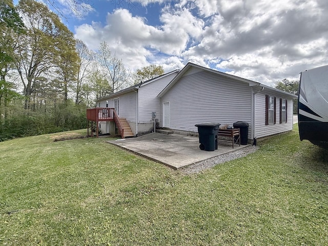 1319 Jacobs Ave, Bridgeport, AL 35740 - rear view of property featuring a lawn, a wooden deck, a patio area, and stairs