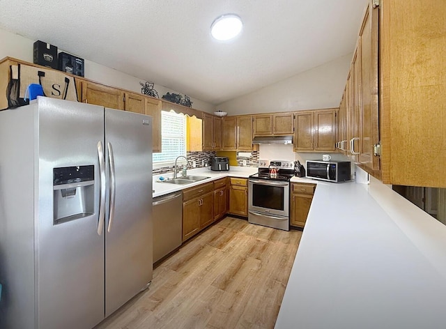 1319 Jacobs Ave, Bridgeport, AL 35740 - kitchen with light wood finished floors, under cabinet range hood, stainless steel appliances, light countertops, and a sink