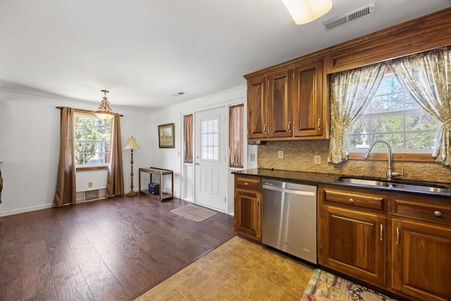 kitchen with visible vents, a sink, a healthy amount of sunlight, backsplash, and stainless steel dishwasher