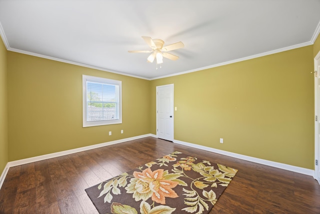 empty room with dark wood-type flooring, baseboards, ceiling fan, and crown molding