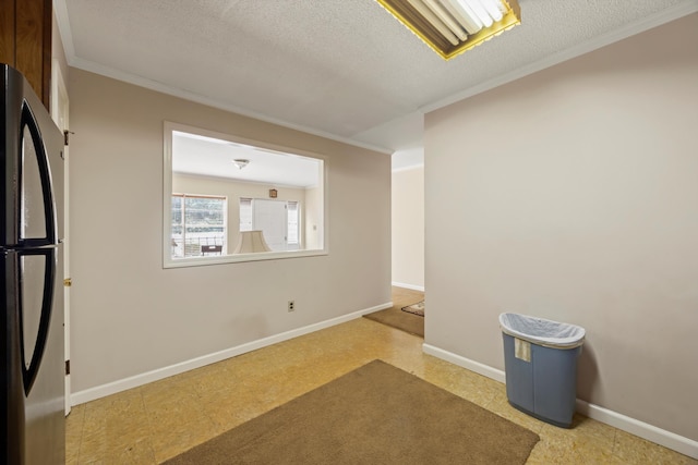 unfurnished room featuring ornamental molding, baseboards, tile patterned floors, and a textured ceiling