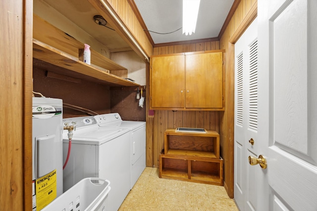 washroom featuring washer and dryer, water heater, and light floors