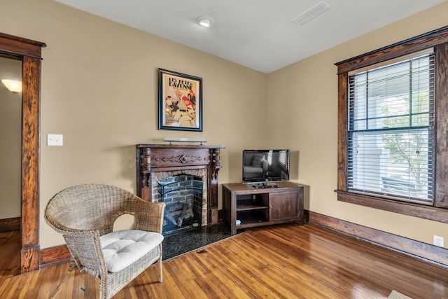 212 Jarnigan Ave, Chattanooga, TN 37405 - living area with baseboards, a fireplace, visible vents, and wood finished floors