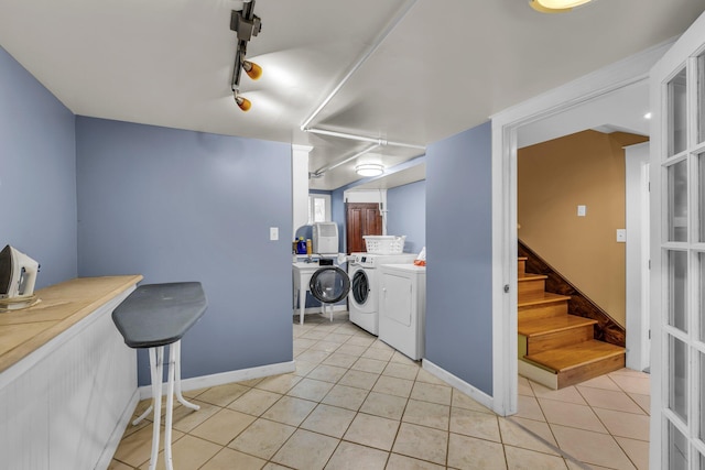 212 Jarnigan Ave, Chattanooga, TN 37405 - clothes washing area featuring light tile patterned flooring, baseboards, separate washer and dryer, and laundry area