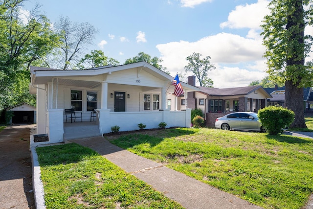 2510 Vine St, Chattanooga, TN 37404 - bungalow-style home featuring driveway, a chimney, covered porch, an outdoor structure, and a front yard