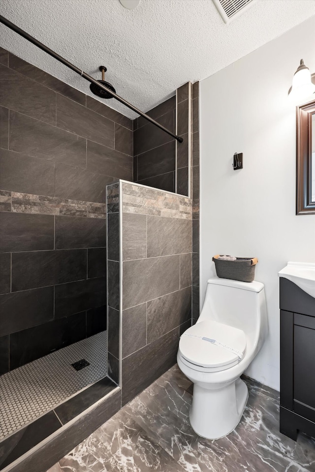 9027 Wooten Rd, Chattanooga, TN 37416 - full bathroom featuring a textured ceiling, vanity, marble finish floor, walk in shower, and toilet