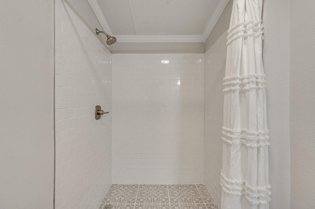 bathroom with tiled shower and ornamental molding