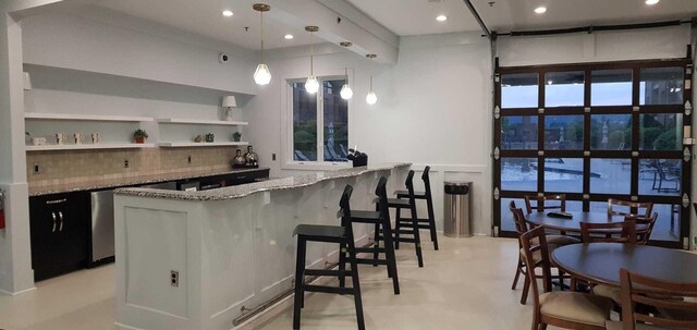 200 Manufacturers Rd Apt 428, Chattanooga, TN 37405 - community bar area featuring decorative backsplash, recessed lighting, and hanging light fixtures