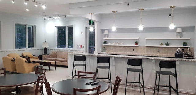 200 Manufacturers Rd Apt 428, Chattanooga, TN 37405 - kitchen with tasteful backsplash, light stone countertops, and a breakfast bar area