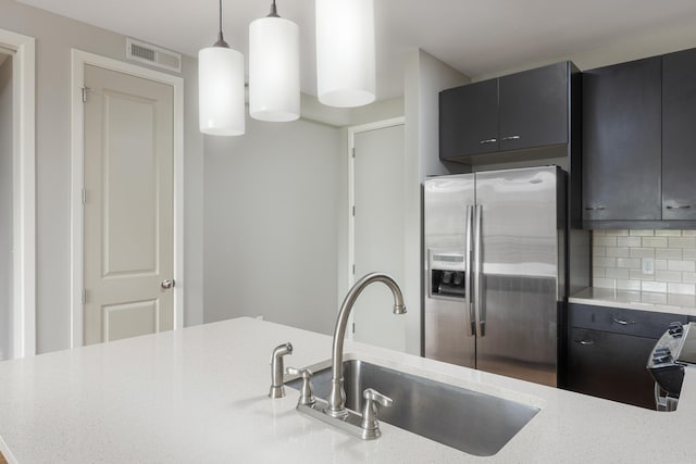 200 Manufacturers Rd Apt 428, Chattanooga, TN 37405 - kitchen with stainless steel refrigerator with ice dispenser, a sink, tasteful backsplash, hanging light fixtures, and dark cabinets